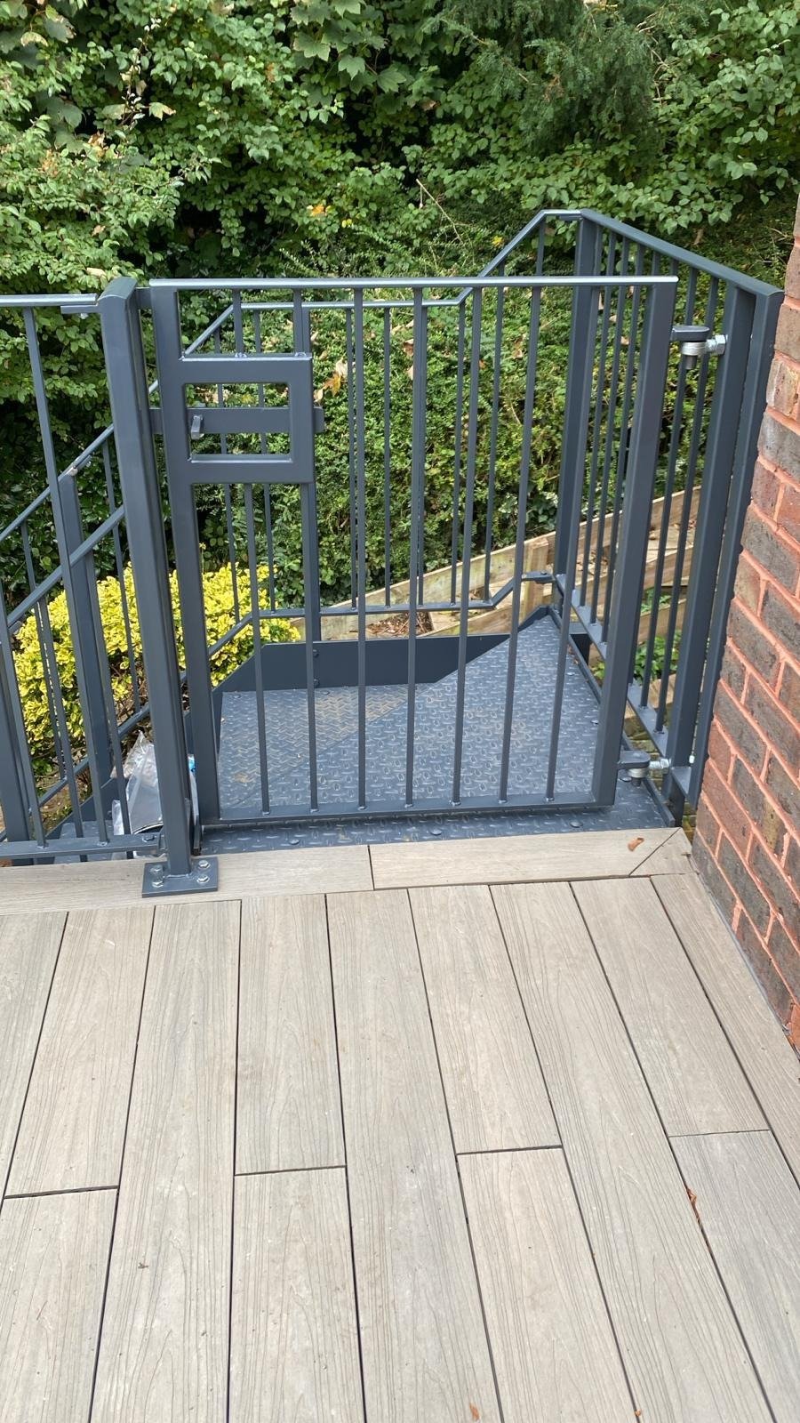 Grey steel gate and railings on a roof terrace