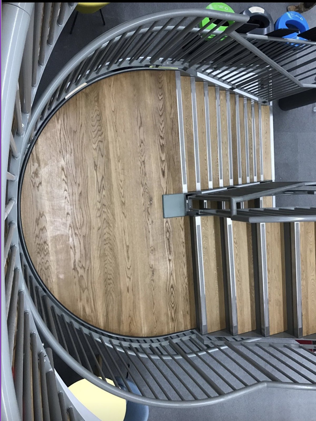 Steel spiral staircase with oak treads seen from above